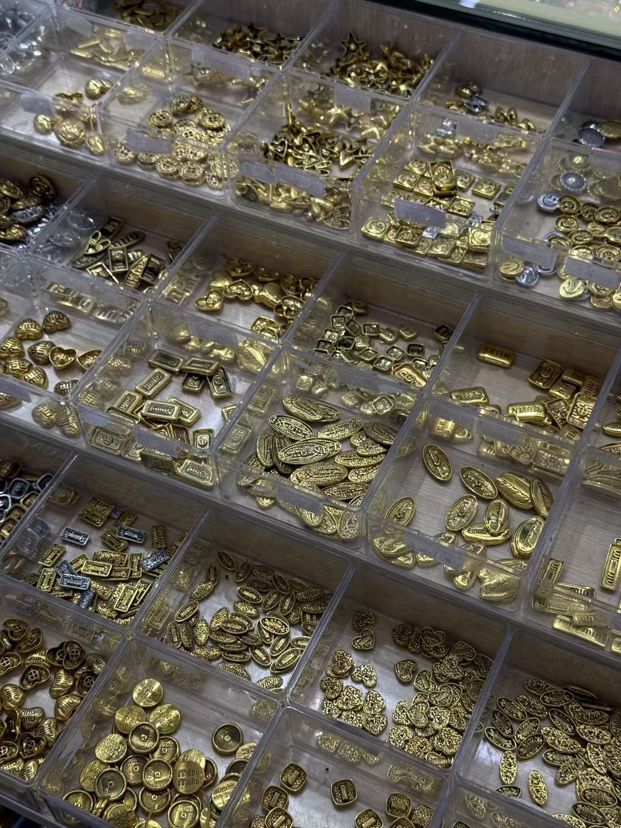 Close view of jewelry and accessory components organised by finish and design